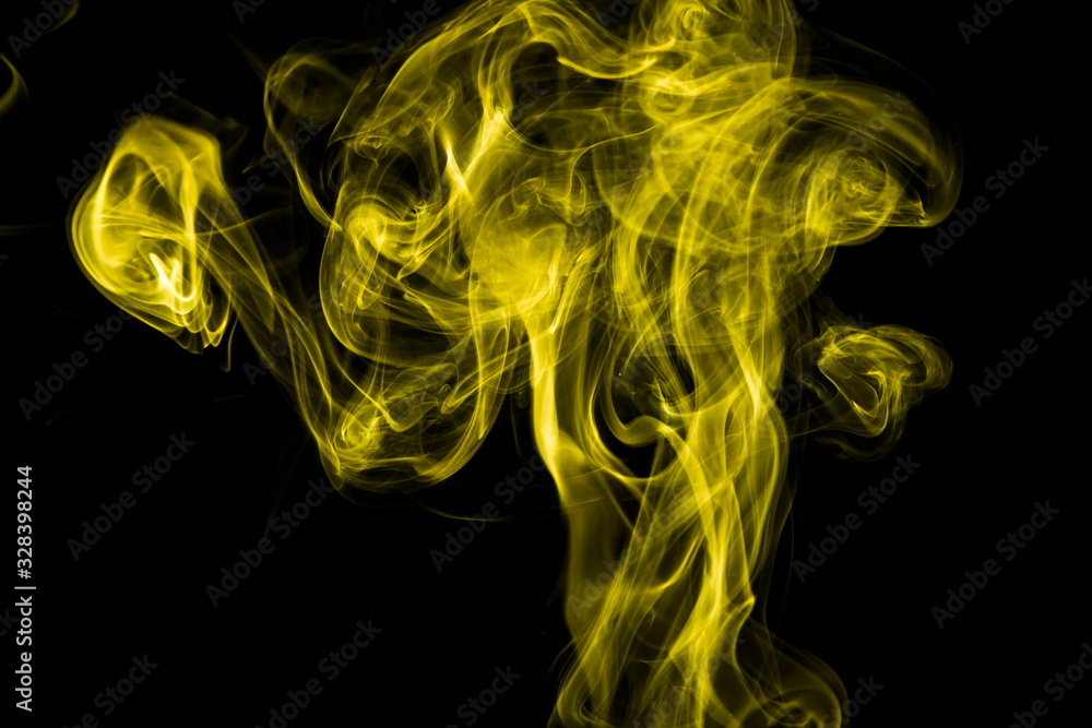 Obraz premium Yellow smoke on black background