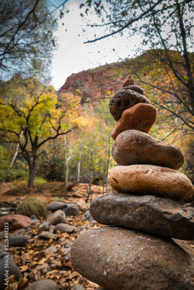Stacked rocks in tranquil nature surroundings with mountains and trees Stacked rocks in tranquil nature surroundings with mountains and trees