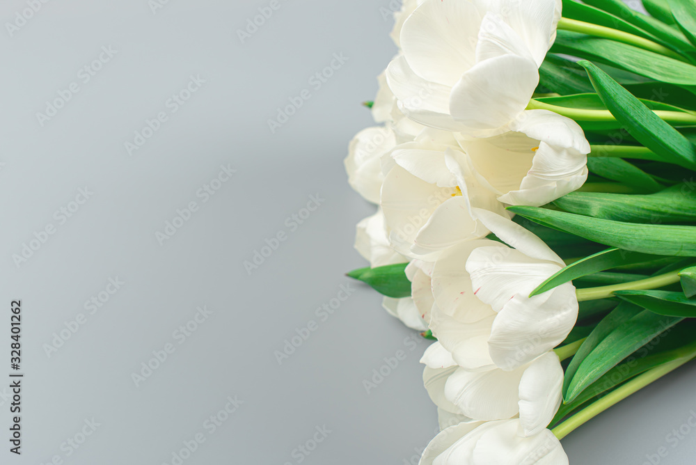 Bouquet of tulips on a gray background with place for text. spring flowers. a bouquet of flowers for the holiday close-up top view. natural background