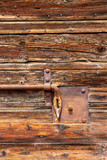 Old wooden weathered door with a rusty latch in Mantova or Mantua, Lombardy, Italy