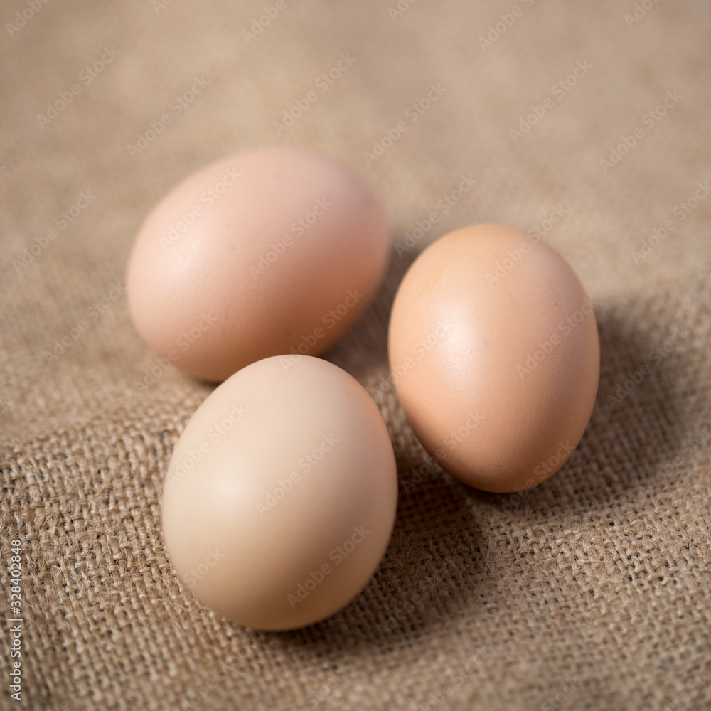 Beautiful brown yellow eggs on the brown cloth Beautiful brown yellow eggs on the brown cloth