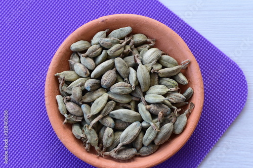 Dry cardamom seed (Elettaria cardamomum) displayed in containers