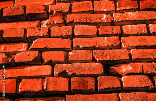 Brick stone wall rough red orane surface as backdrop background texture photo