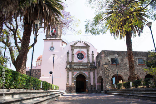 Stone church in Asunción neighborhood wrapped between cobbled streets and fruit and ornamental trees give life to the town