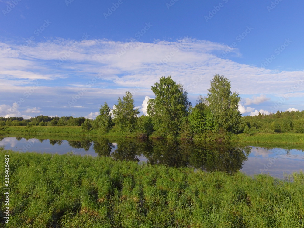 The old channel of the Vychegda river against a blue sky with clouds , Komi Republic, Russia The old channel of the Vychegda river against a blue sky with clouds , Komi Republic, Russia