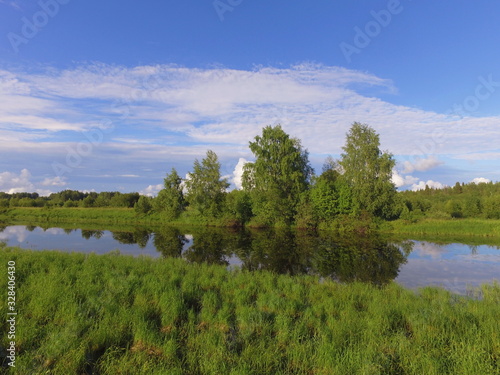 The old channel of the Vychegda river against a blue sky with clouds , Komi Republic, Russia