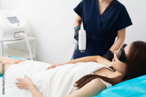 Woman getting laser treatment in a beauty salon.