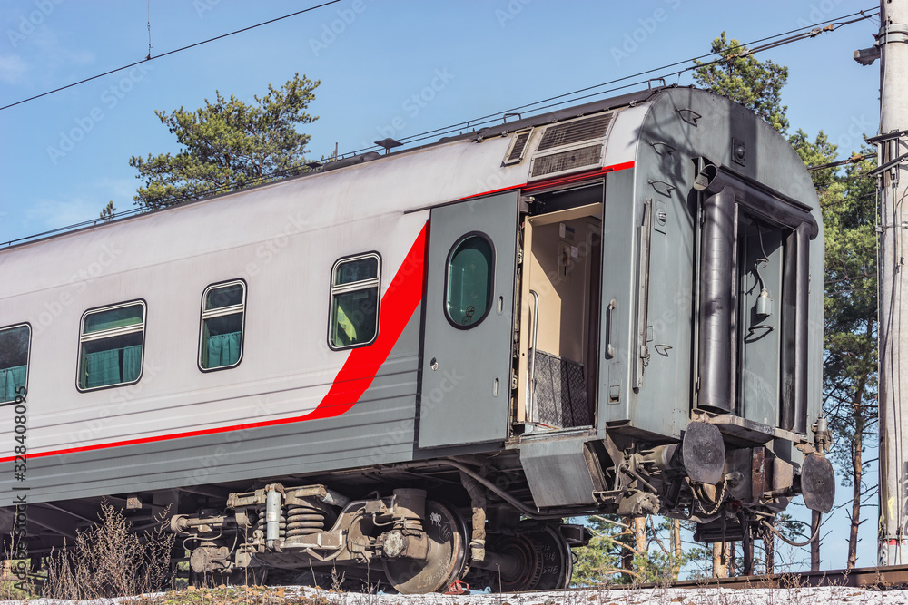 Last railway carriage of the train with the open door. Last railway carriage of the train with the open door.