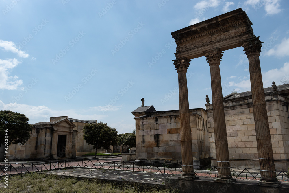 BOGOTÁ, COLOMBIA - MARCH 01 OF 2020: Three ancient  pillars, old crypts and mausoleums located in Cementerio central downtown city in sunny day