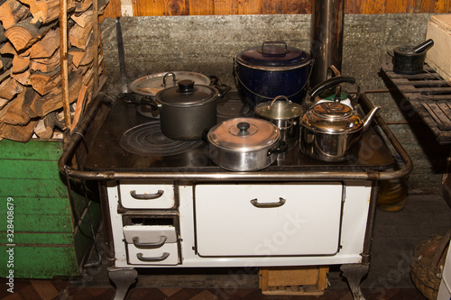 White wood stove with many holes on top, perfect for heating the house and making food, widely used in chile