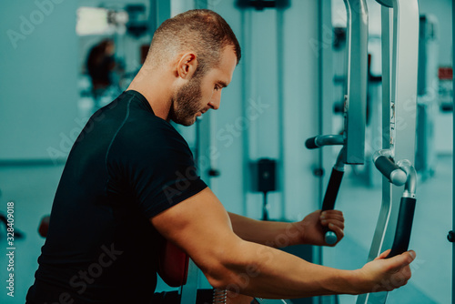 sport, bodybuilding, lifestyle and people concept - young man with barbell flexing muscles and making shoulder and chest press lunge in gym