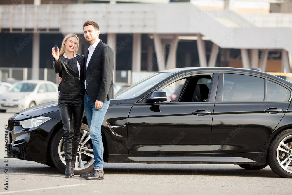 custom made wallpaper toronto digitalHappy young couple chooses and buying a new car for the family.