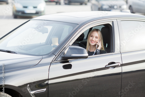 Young happy woman bought new modern car