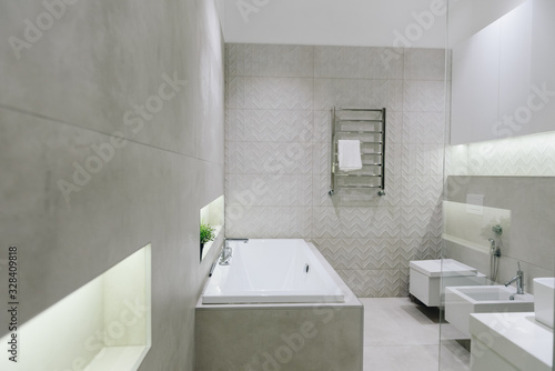 Stylish modern bathroom interior, beautiful minimalistic design with toilet, bidet, bathtub photo