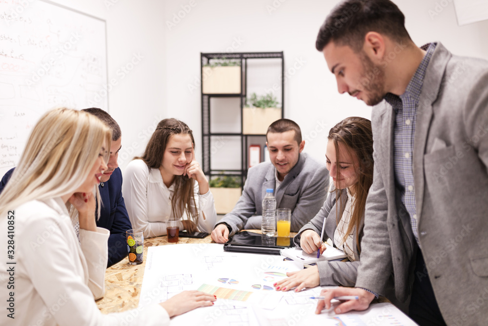 group of successful young architects and businessmen in modern workplace, having a creative meeting. group of successful young architects and businessmen in modern workplace, having a creative meeting.