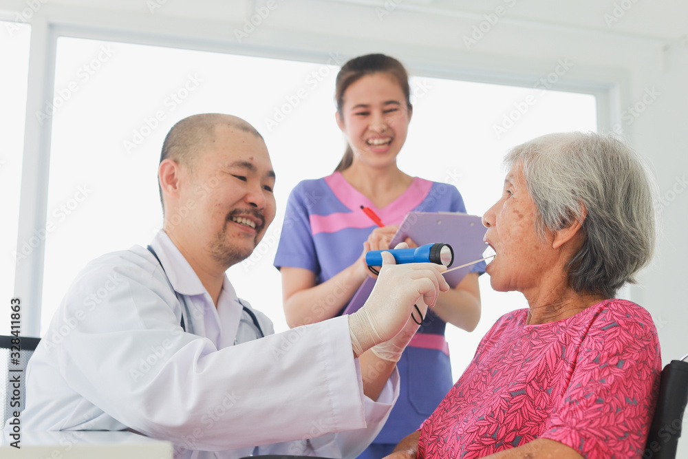 Asian Old Patient woman Talking with Medical Doctor in clinic office hospital Asian Old Patient woman Talking with Medical Doctor in clinic office hospital