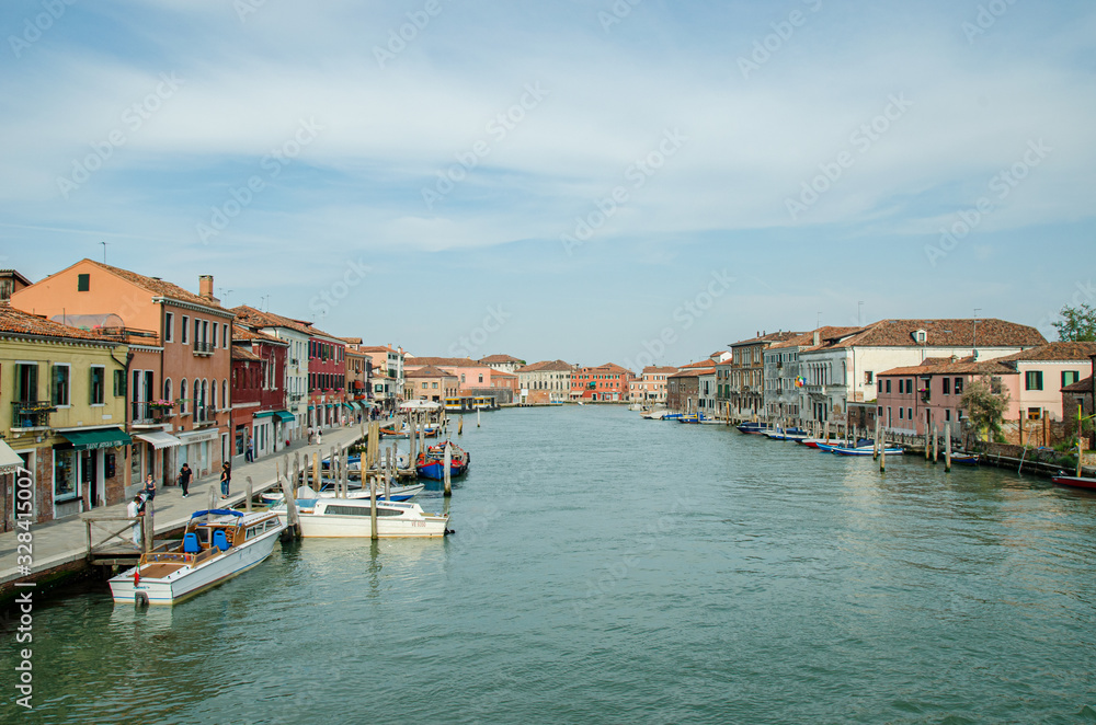 Venice, Italy May 18, 2015: View of beautiful canals and boats docked alongside the walkways in Venice Italy