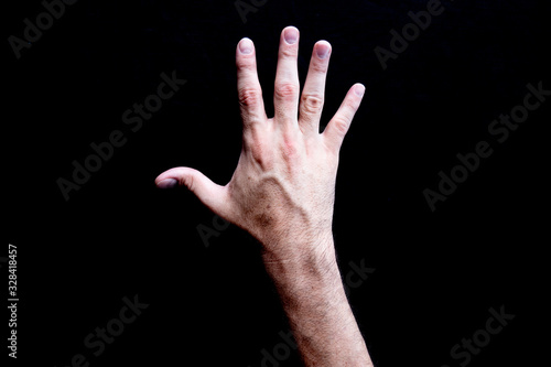 Canvastavla Open white adult male veiny hand with palm facing down on a black background