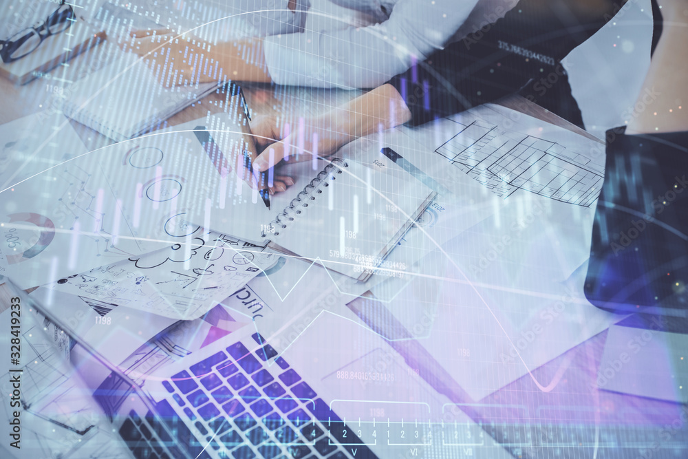A woman hands writing information about stock market in notepad. Forex chart holograms in front. Concept of research. Double exposure A woman hands writing information about stock market in notepad. Forex chart holograms in front. Concept of research. Double exposure