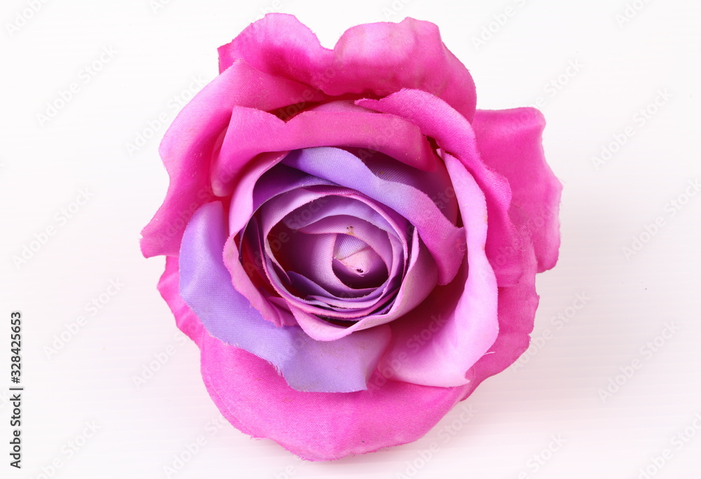 Artificial violet roses on white background Artificial violet roses on white background