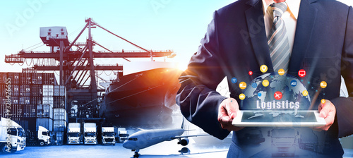 Multiple exposures of Businessman touching tablet for analyze stock at logistics port and world map with logistic network distribution on background, transportation trading business  © Travel mania