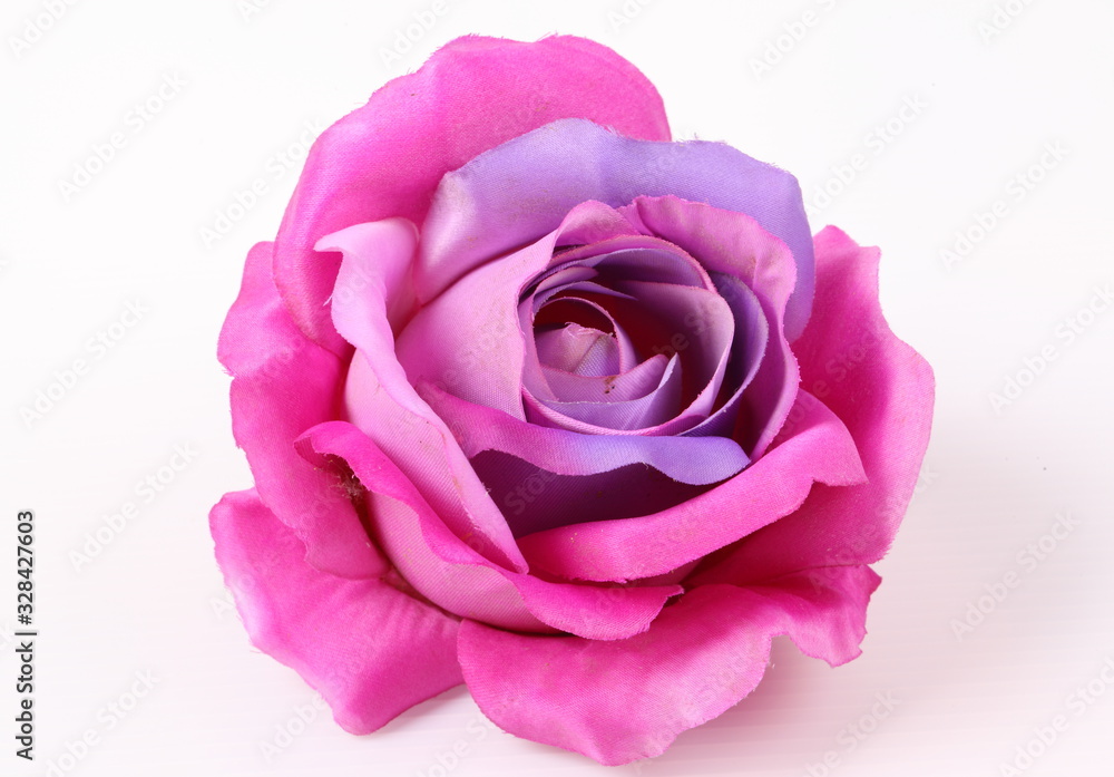 Artificial violet roses on white background Artificial violet roses on white background