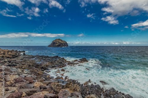 A rocky beach with little waves at Tenerife island - Canary Spain