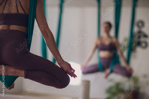 Aerial yoga. Self-care woman practicing yoga.