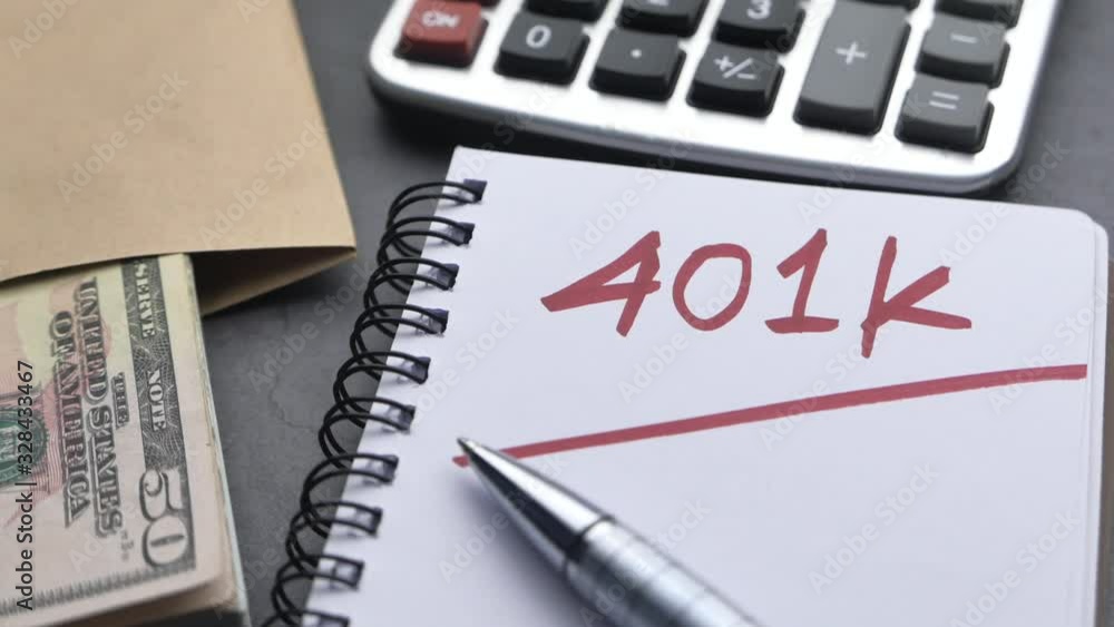 401k text on notepad with coins and keyboard on table 401k text on notepad with coins and keyboard on table
