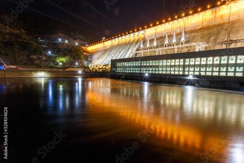 Industrial photography. General view of the Zeya Dam at night. Beautiful backlight hydroelectric power station.