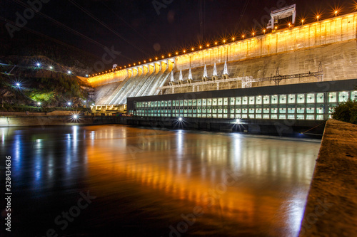 Industrial photography. General view of the Zeya Dam at night. Beautiful backlight hydroelectric power station. © alexhitrov