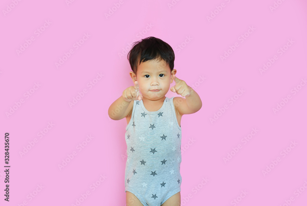 Portrait of smiling asian baby boy pointing at camera isolated over pink background. Portrait of smiling asian baby boy pointing at camera isolated over pink background.