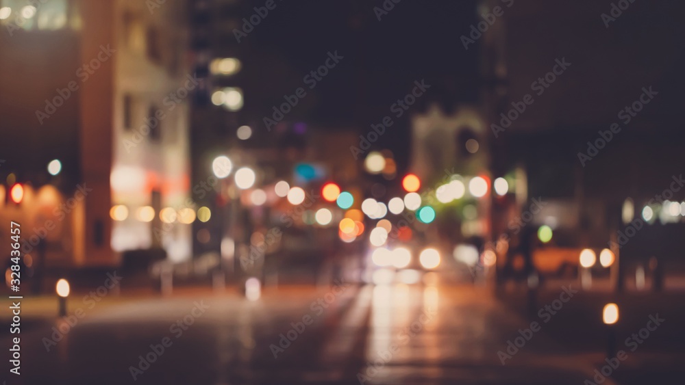 Abstract blur urban city street road with people walking and lighting bokeh for background.