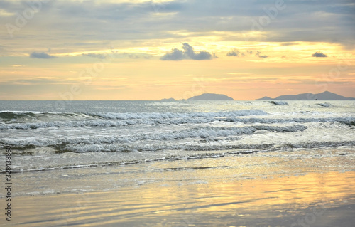 Beautiful sea view of gold light reflect with sea wave in twilight time.