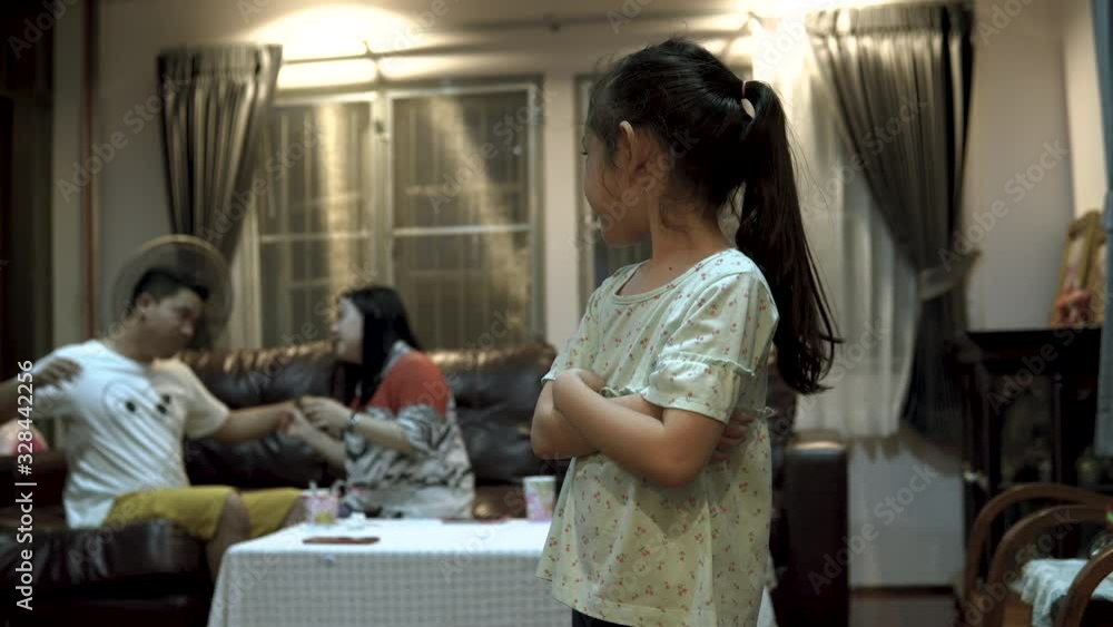 Sad little girl looking her parents arguing on background, problems in family Sad little girl looking her parents arguing on background, problems in family
