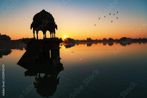 Gadsar Lake at Jaisalmer Rajasthan at sunrise with ancient architecture in silhouette © Roop Dey