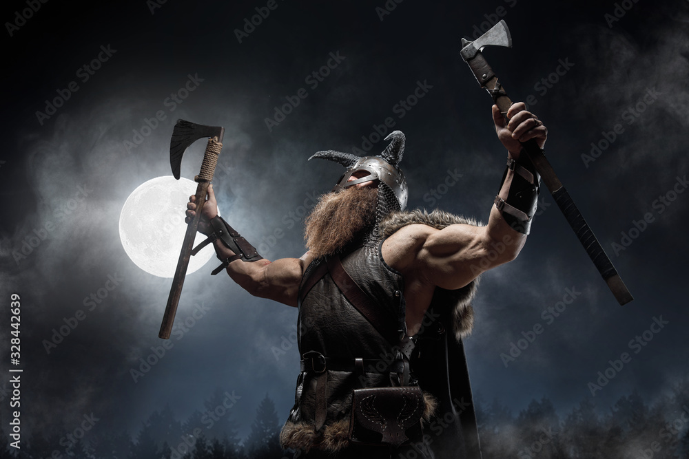 Fotografiet, Poster Medieval warrior berserk Viking with tattoo with axes  attacks enemy på Europosters.se