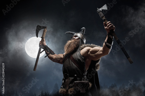 Wallpaper Mural Medieval warrior berserk Viking with tattoo with axes attacks enemy