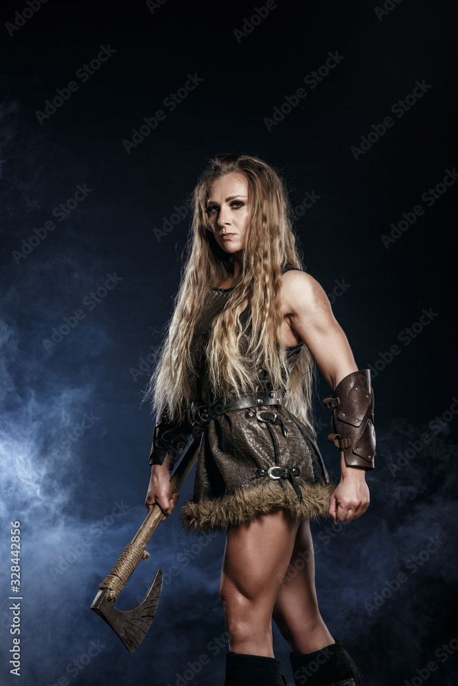 Beautiful female viking woman warrior in battle with big two-handed sword.  Ancient times. Amazon fantasy blonde hair sexy girl. Stock Photo | Adobe  Stock
