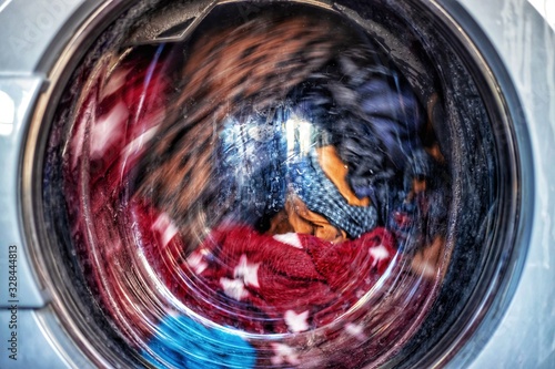 Wallpaper Mural Washing Clothes. Laundromat Clothes tumble washing in machine close up Torontodigital.ca