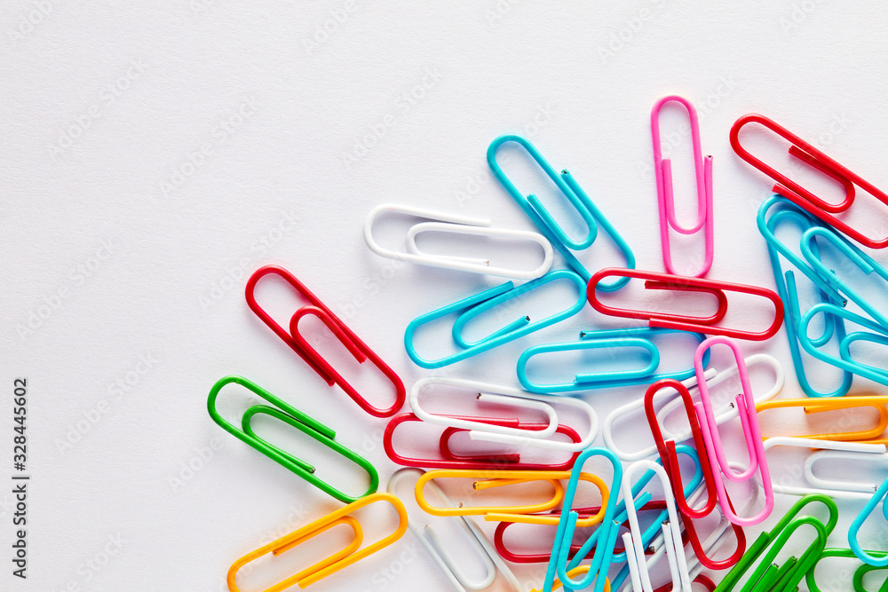 Heap of colorful paper clips on white background with copy space. Heap of colorful paper clips on white background with copy space.