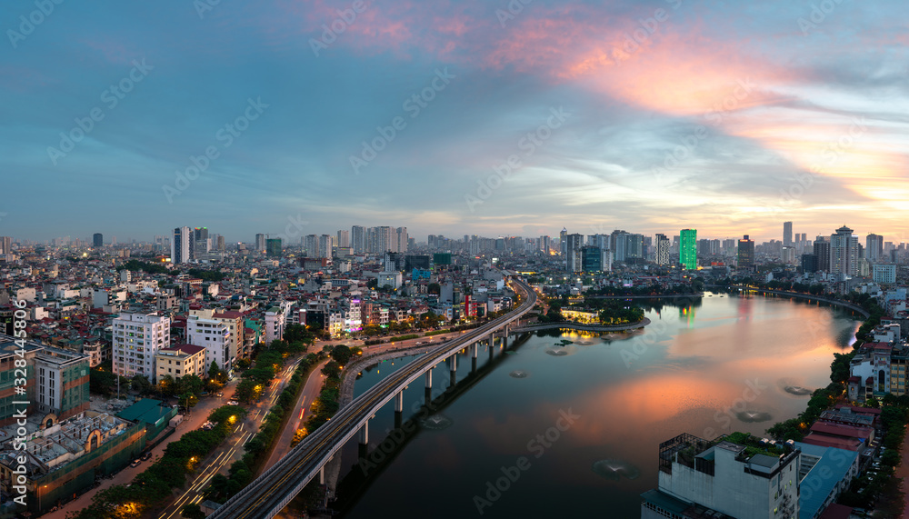 Fototapeta premium Hanoi cityscape during sunset period. Skyline view of Hanoi at Hoang Cau lake