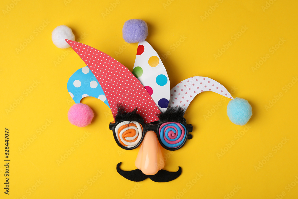 Funny face made of party items on yellow background, flat lay. April Fool's Day - obrazy, fototapety, plakaty 