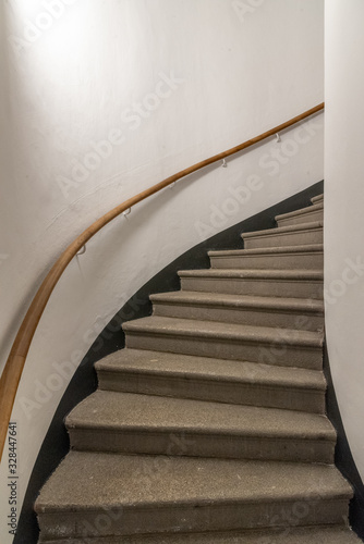 narrow old staircase with handrail