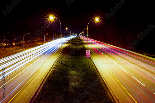 Obraz na płótnie Light trails on highway at night. View from pedestrian overpass w salonie