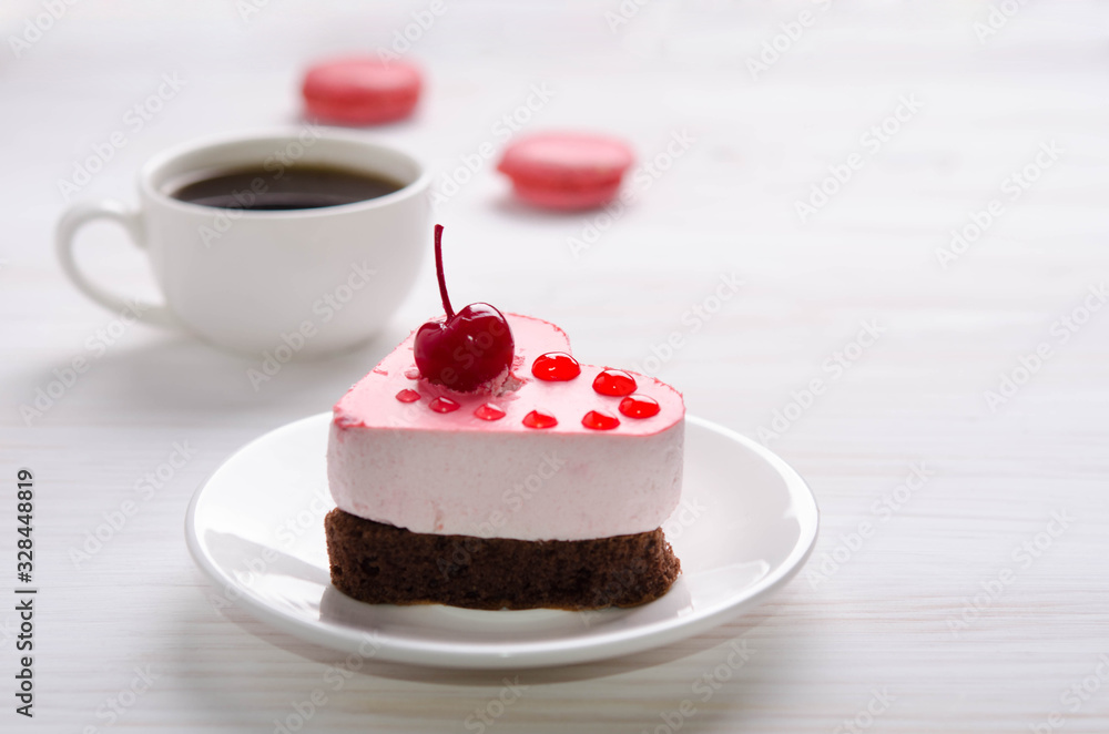 souffle cake in the form of heart with cup of coffe and macaroons on a wooden table souffle cake in the form of heart with cup of coffe and macaroons on a wooden table