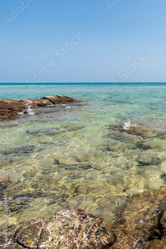beautiful soft wave clear blue transparency sea ocean water and rocks at the bottom of the tropical paradise beach coast summer sea view at PP Island, Krabi, Phuket, Thailand.