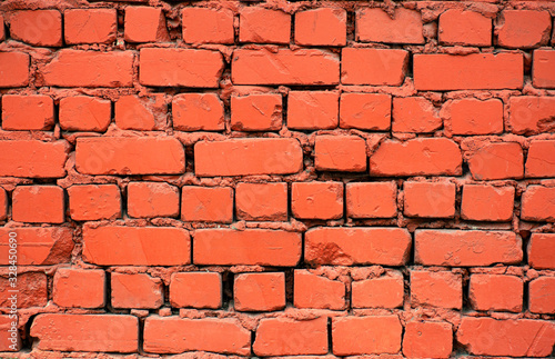 Old brick wall. Brickwork from an old brick in a rustic style. The structure and pattern of the destroyed stone wall. Copy space