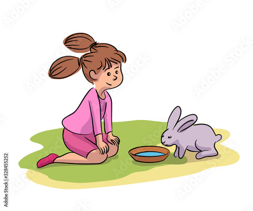 Little girl giving water cute rabbit on farm yard