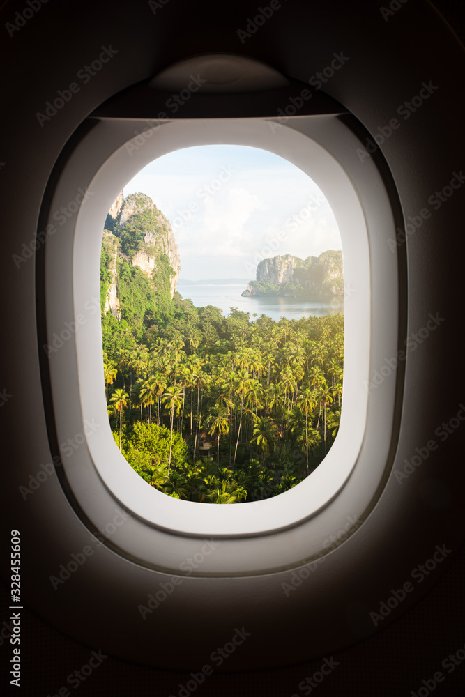 Green coconut tree on Railey beach in Krabi, Thailand, view in frame window plane